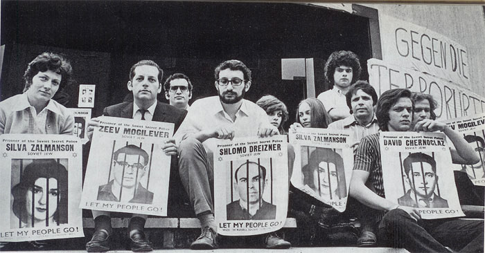 Hunger strike of 3 days in solidarity with the Soviet Prisoners of Zion.
May 1971, Duesseldorf, West Germany. The building in the background is the synagogue of Duesseldorf were the hunger strike took place.
From left to right, first row: Elisabeth Berkes, Joel Berger, Daniel "Tutti" Izchak Katz,
Jossi Reich; second row: Ari Rosenblatt, Dalia Reich, Esther Auerbach, Jossi Borenstein, Dubbi Schkolnik, Heinz Szeinwald; there was one more participant in this hunger strike, Peter Rimoczi, who isn't seen behind the extreme right poster.

Photo was published in the book DAS JAHR IM BILD [Images of the year] - 1971, CARLSEN VERLAG, Germany, page 57, and presented to the Remember and Save Association by Daniel "Tutti" Itzhak Katz.